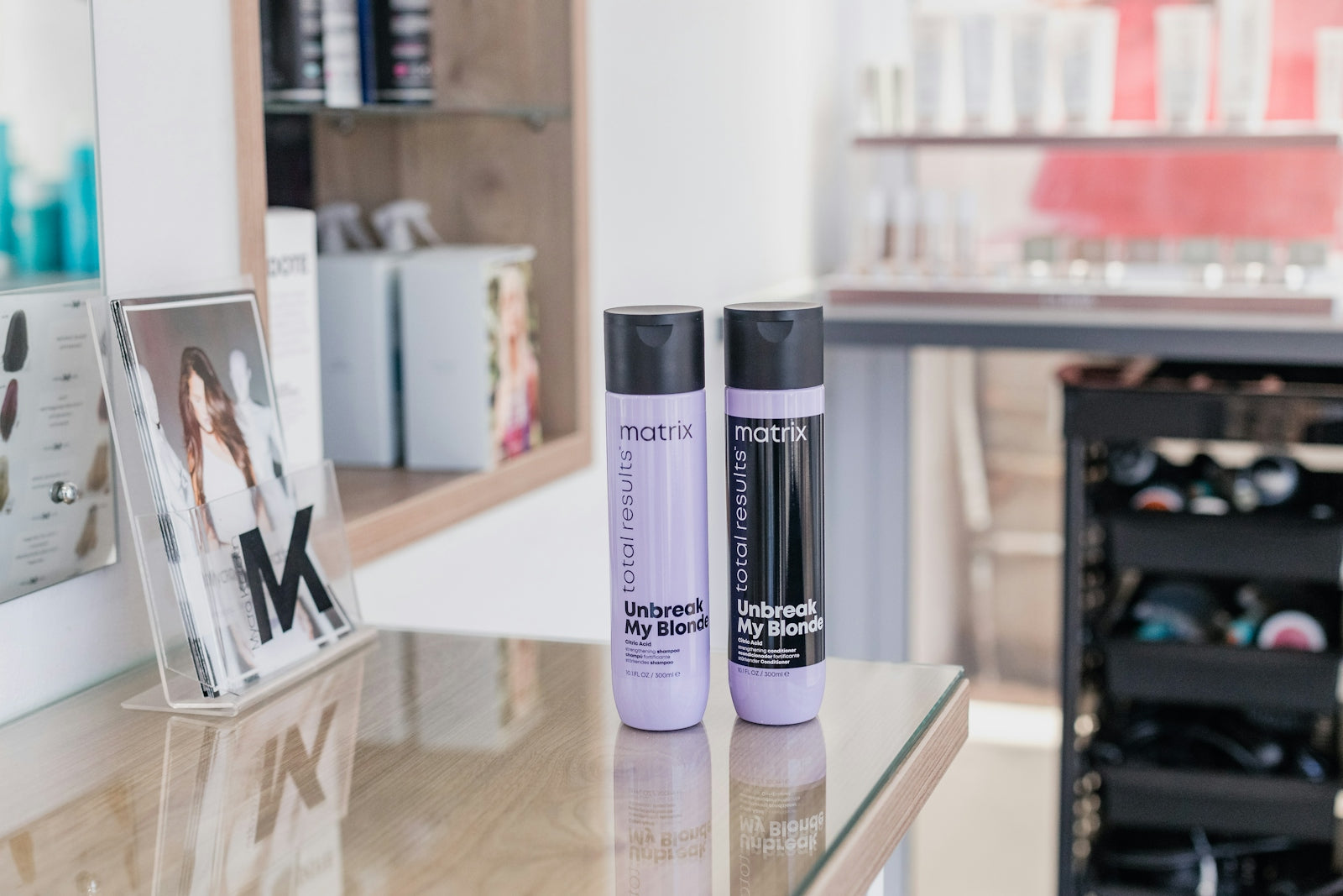 two bottles of hair products sitting on a table