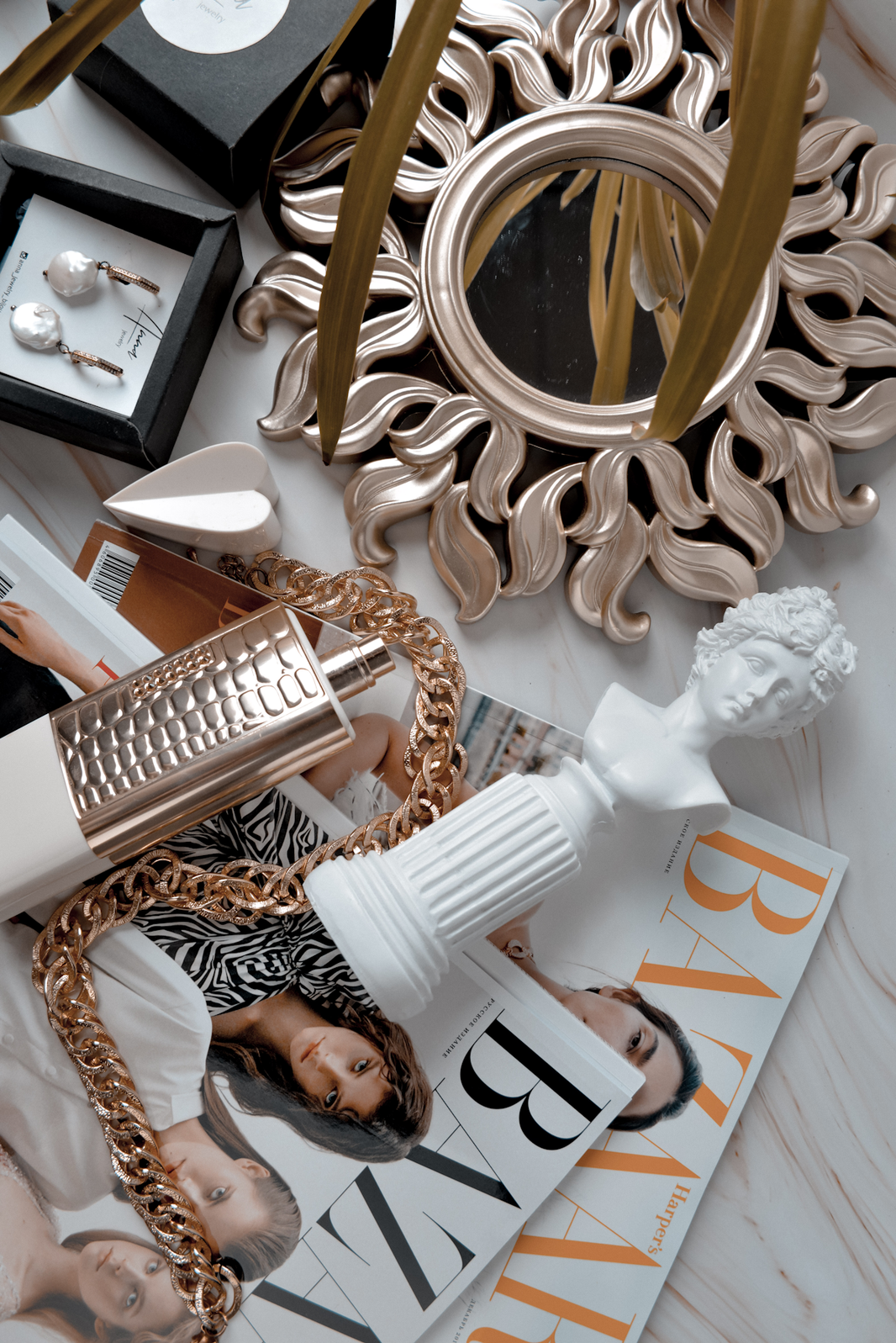 a table topped with jewelry and a mirror