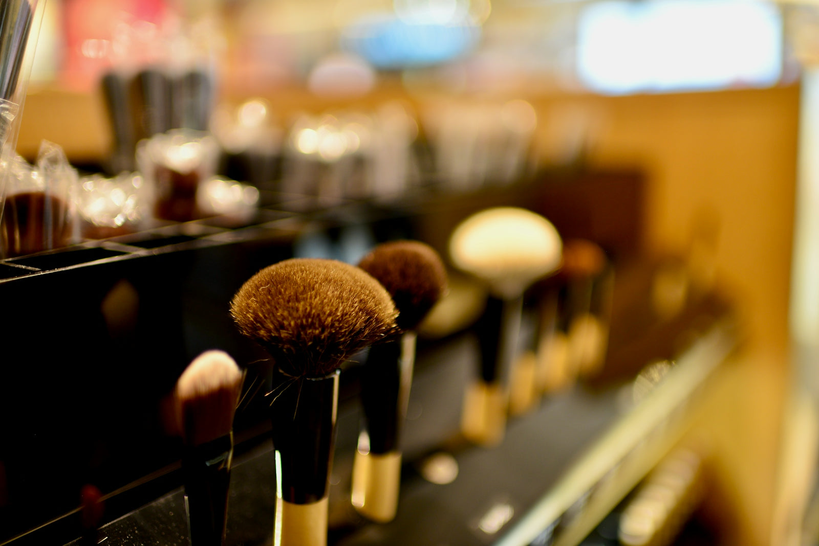 a row of makeup brushes sitting on top of a counter