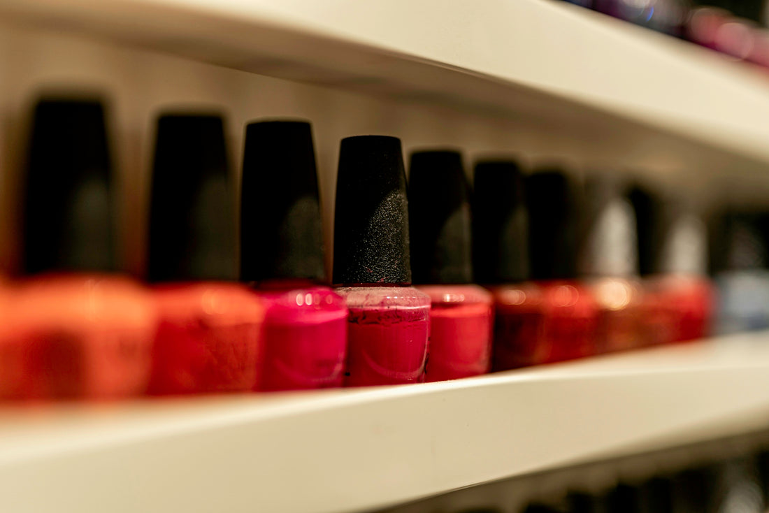 a row of bottles of nail polish on a shelf
