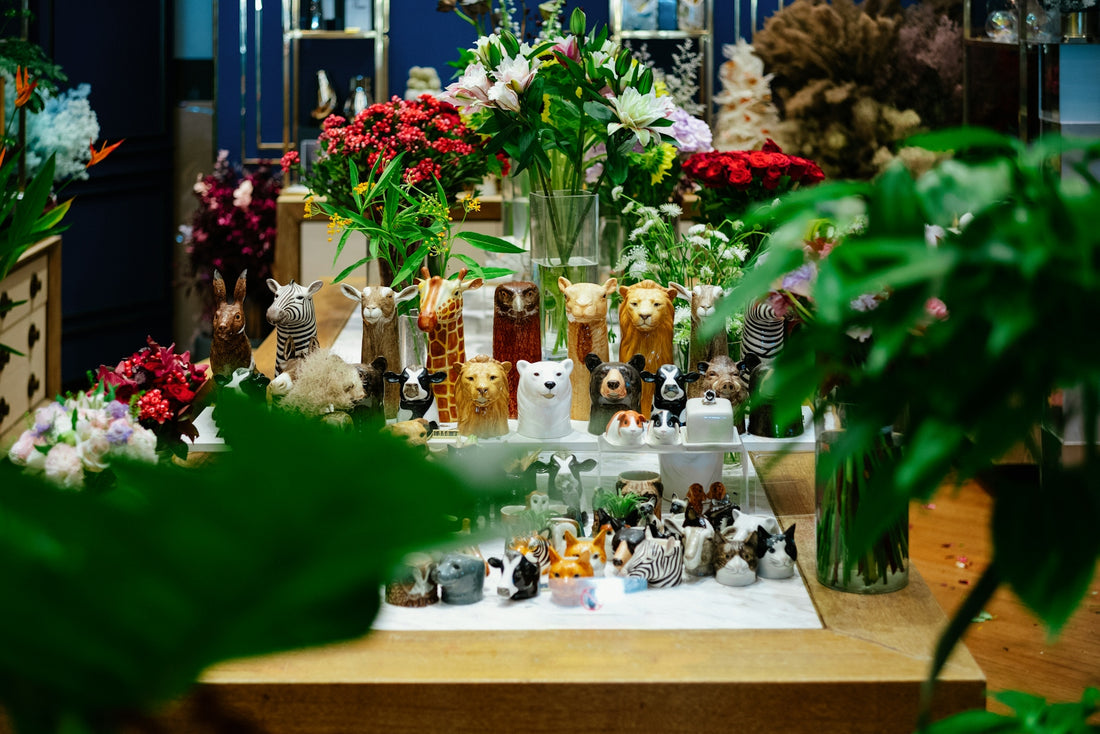 a display of various vases and flowers