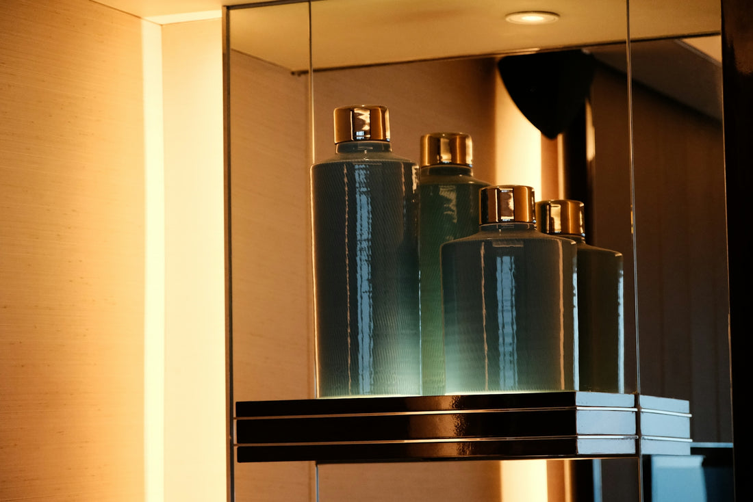 A bathroom mirror with a lot of bottles in it