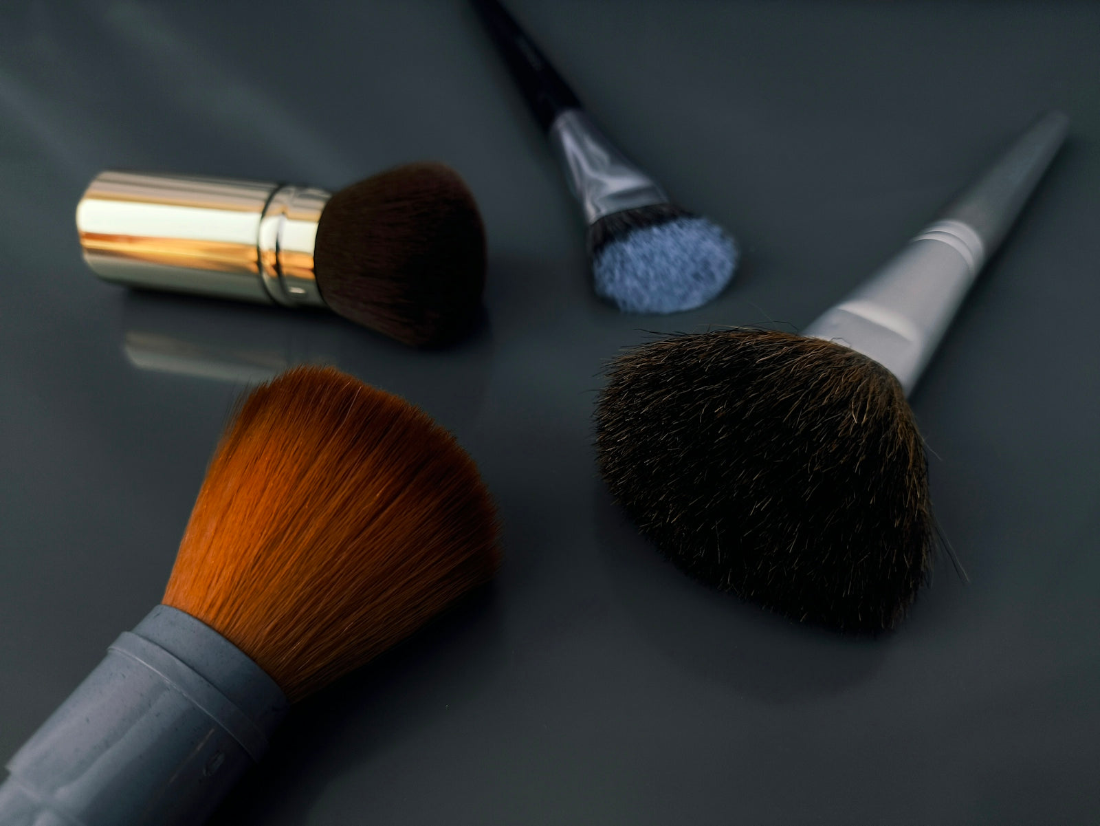A close up of a brush and two other brushes