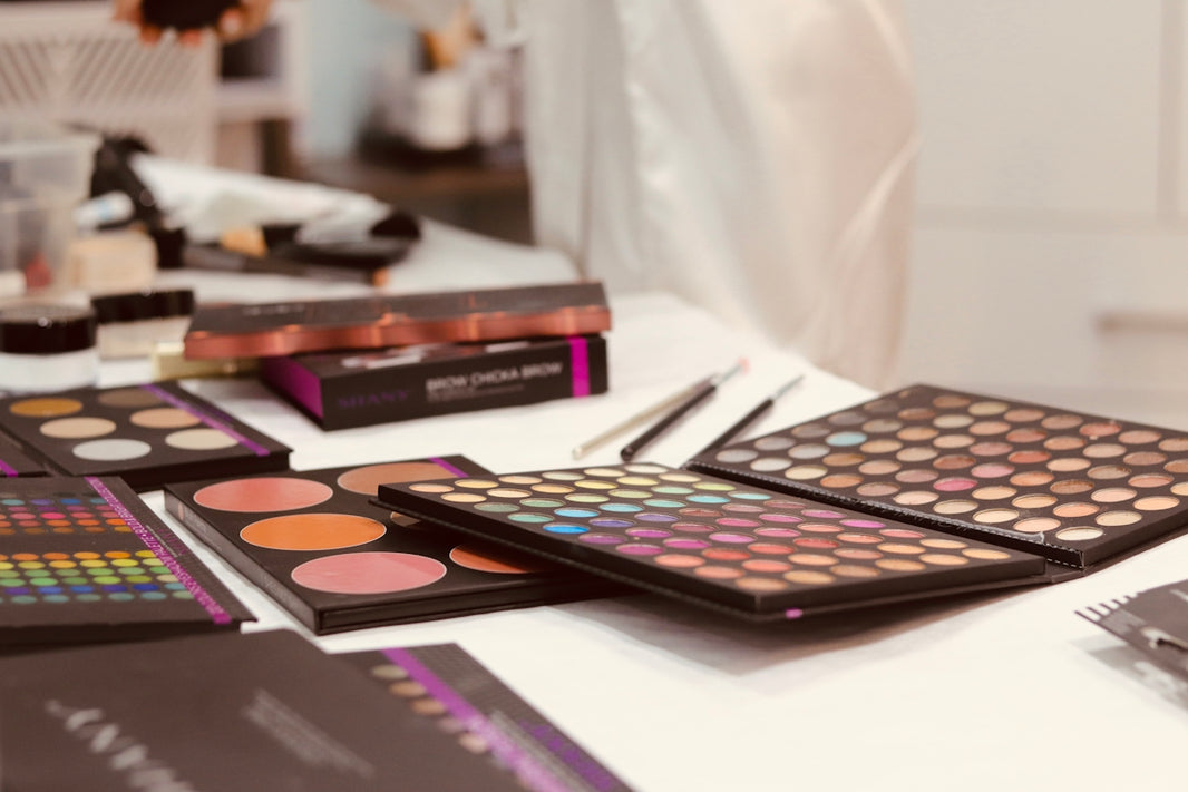 A table topped with lots of different types of makeup